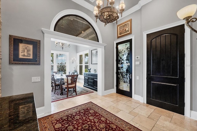 3866 Turtle Dove Blvd, Punta Gorda, FL 33950 - entryway featuring a chandelier, baseboards, stone tile floors, and a high ceiling