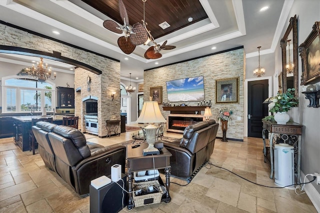 3866 Turtle Dove Blvd, Punta Gorda, FL 33950 - living room with a chandelier, a tray ceiling, stone tile flooring, a ceiling fan, and recessed lighting