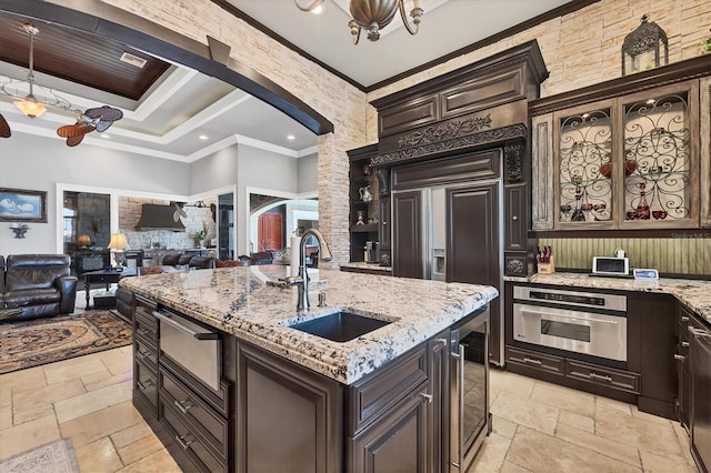 3866 Turtle Dove Blvd, Punta Gorda, FL 33950 - kitchen featuring a sink, wine cooler, stone tile floors, arched walkways, and ornamental molding