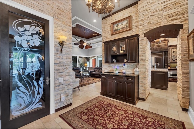 3866 Turtle Dove Blvd, Punta Gorda, FL 33950 - bar area featuring stone tile flooring, arched walkways, a chandelier, a sink, and recessed lighting