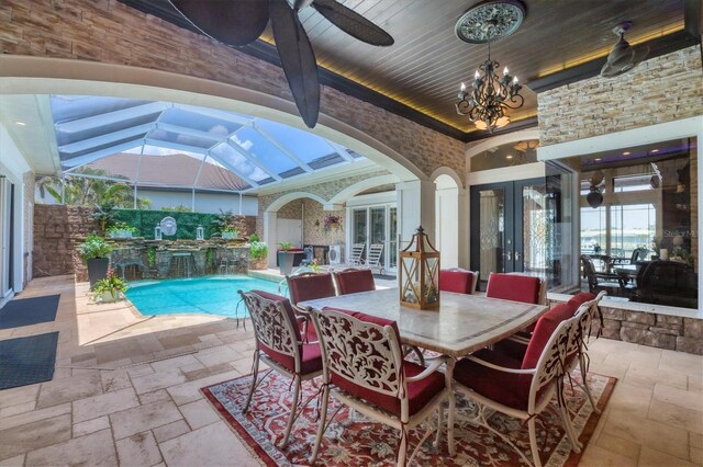 3866 Turtle Dove Blvd, Punta Gorda, FL 33950 - dining room with stone tile floors, a sunroom, high vaulted ceiling, french doors, and a ceiling fan