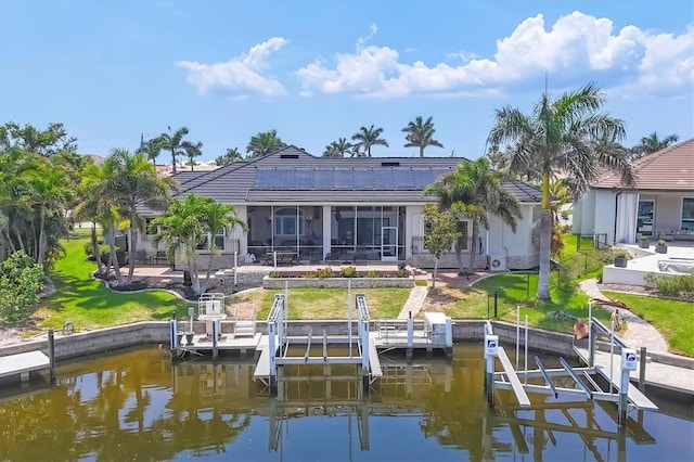 3866 Turtle Dove Blvd, Punta Gorda, FL 33950 - rear view of house with boat lift, a water view, and a sunroom