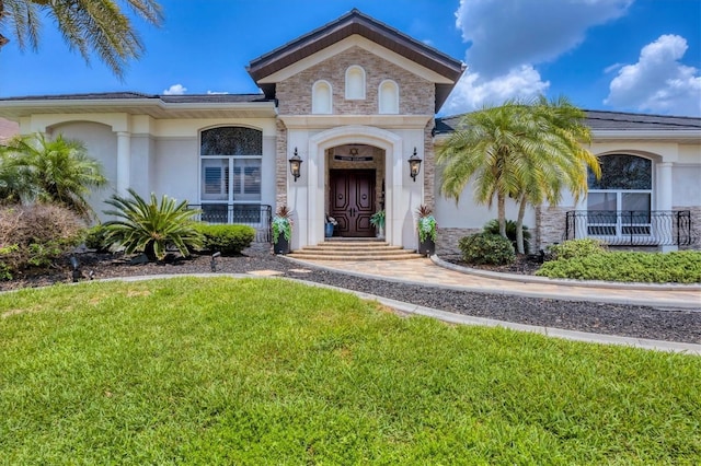 3866 Turtle Dove Blvd, Punta Gorda, FL 33950 - doorway to property featuring a lawn, stucco siding, and covered porch