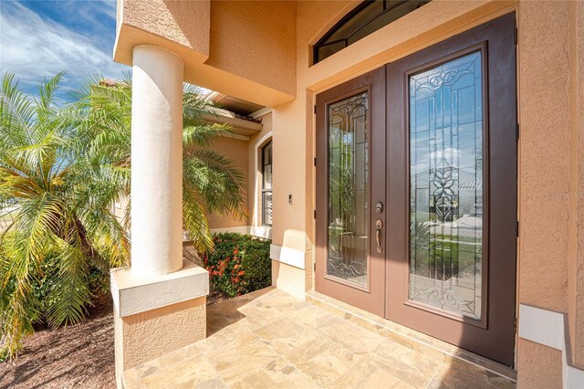 4015 La Costa Island Ct, Punta Gorda, FL 33950 - doorway to property featuring french doors and stucco siding