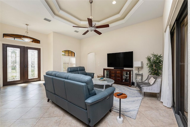 4015 La Costa Island Ct, Punta Gorda, FL 33950 - living area with arched walkways, french doors, light tile patterned flooring, ceiling fan, and a raised ceiling