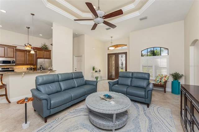 4015 La Costa Island Ct, Punta Gorda, FL 33950 - living area with ceiling fan, a tray ceiling, a high ceiling, light tile patterned flooring, and crown molding