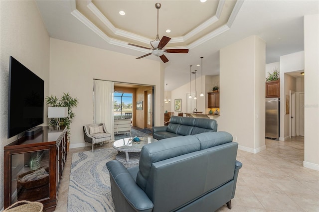 4015 La Costa Island Ct, Punta Gorda, FL 33950 - living room with a ceiling fan, a tray ceiling, crown molding, baseboards, and recessed lighting