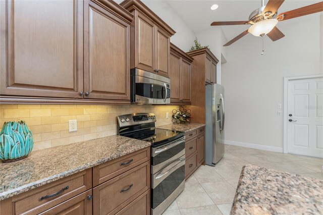4015 La Costa Island Ct, Punta Gorda, FL 33950 - kitchen featuring appliances with stainless steel finishes, tasteful backsplash, ceiling fan, light stone countertops, and recessed lighting