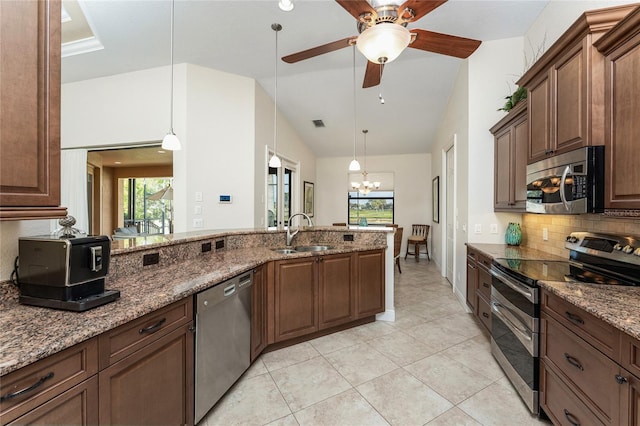 4015 La Costa Island Ct, Punta Gorda, FL 33950 - kitchen featuring appliances with stainless steel finishes, tasteful backsplash, a sink, plenty of natural light, and vaulted ceiling