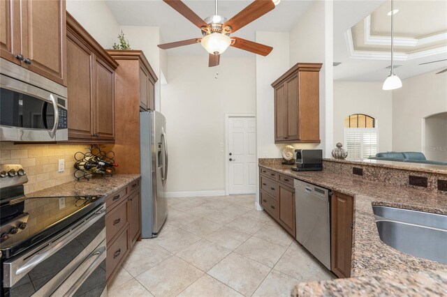 4015 La Costa Island Ct, Punta Gorda, FL 33950 - kitchen featuring stainless steel appliances, ceiling fan, tasteful backsplash, a sink, and dark stone countertops