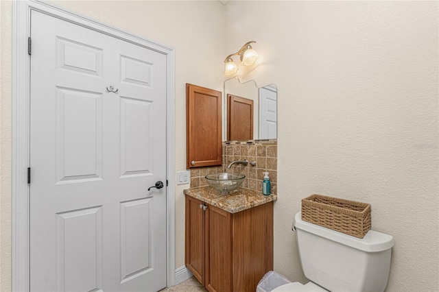 4015 La Costa Island Ct, Punta Gorda, FL 33950 - bathroom featuring vanity, tasteful backsplash, and toilet