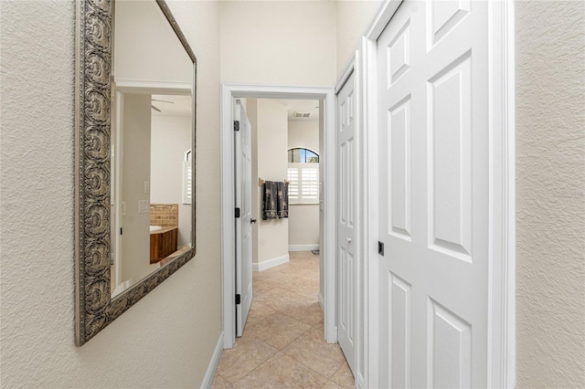 4015 La Costa Island Ct, Punta Gorda, FL 33950 - hall with light tile patterned floors, baseboards, and a textured wall