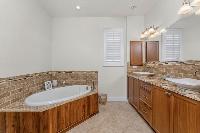 4015 La Costa Island Ct, Punta Gorda, FL 33950 - full bathroom featuring double vanity, a bath, tile patterned flooring, decorative backsplash, and baseboards