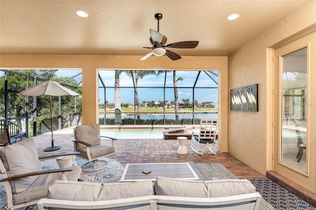 4015 La Costa Island Ct, Punta Gorda, FL 33950 - view of patio featuring glass enclosure, a water view, ceiling fan, and an outdoor living space