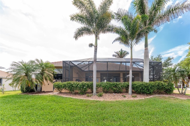 4015 La Costa Island Ct, Punta Gorda, FL 33950 - back of house featuring a lawn, a tile roof, stucco siding, and glass enclosure