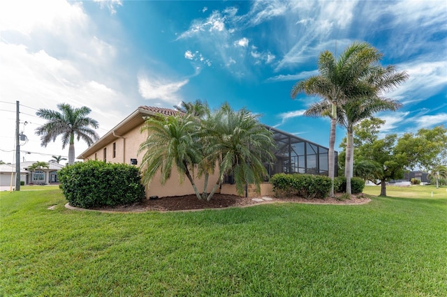 4015 La Costa Island Ct, Punta Gorda, FL 33950 - view of home's exterior featuring a lawn, stucco siding, and a lanai