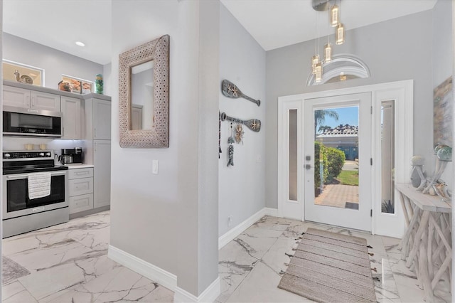 303 11th Ave E, Palmetto, FL 34221 - foyer featuring light marble finish floors, baseboards, and recessed lighting