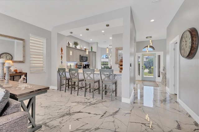 303 11th Ave E, Palmetto, FL 34221 - entryway featuring light marble finish floors, baseboards, and recessed lighting