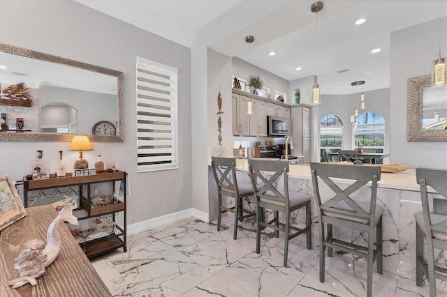 303 11th Ave E, Palmetto, FL 34221 - dining space featuring light marble finish floors, recessed lighting, and baseboards