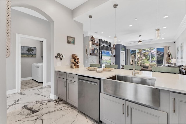303 11th Ave E, Palmetto, FL 34221 - kitchen with stainless steel dishwasher, a sink, light marble finish flooring, gray cabinetry, and washer / clothes dryer
