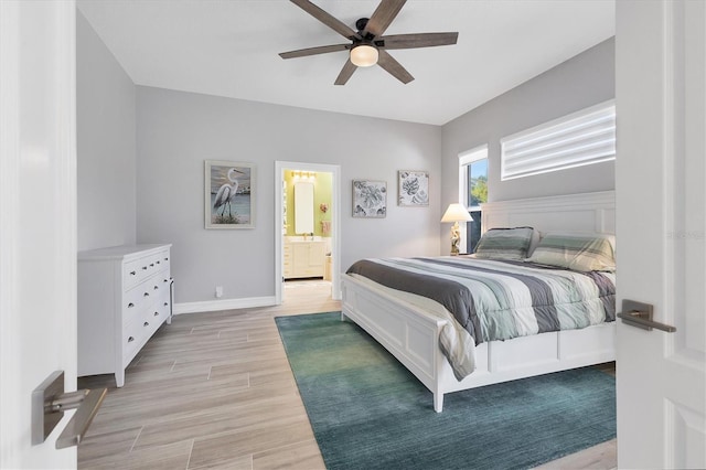 303 11th Ave E, Palmetto, FL 34221 - bedroom with light wood finished floors, baseboards, a ceiling fan, and connected bathroom