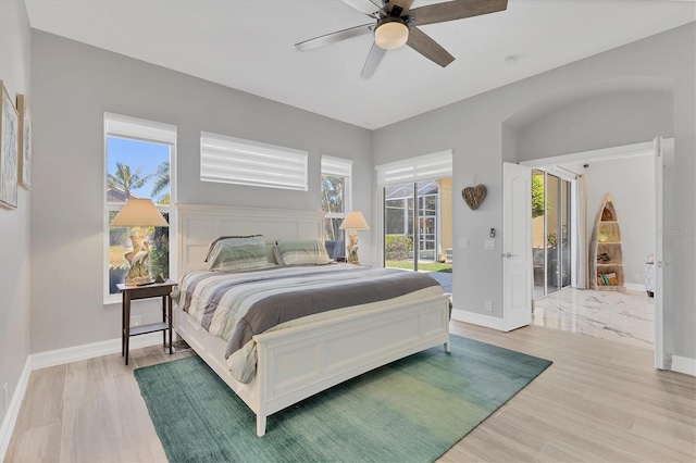 303 11th Ave E, Palmetto, FL 34221 - bedroom featuring baseboards, light wood finished floors, and access to exterior