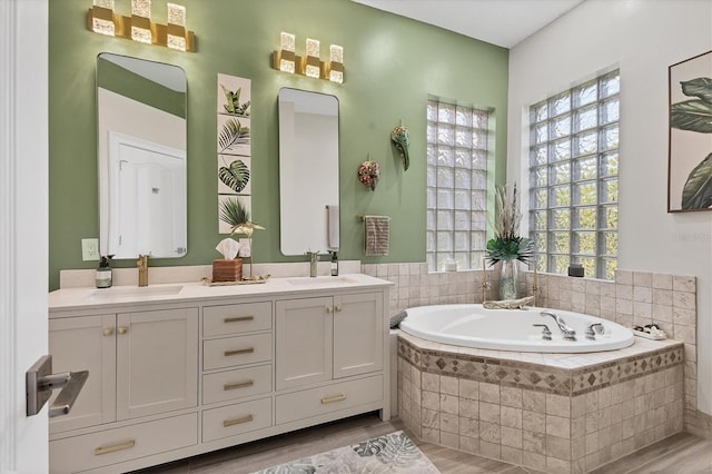 303 11th Ave E, Palmetto, FL 34221 - full bathroom with a garden tub, wood finished floors, and double vanity