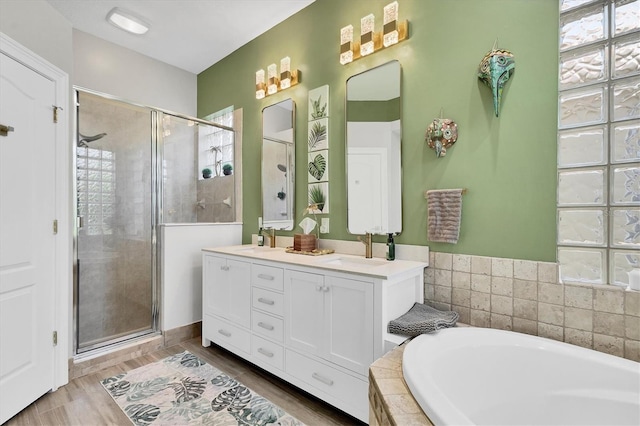 303 11th Ave E, Palmetto, FL 34221 - full bath featuring a shower stall, a garden tub, double vanity, and wood finished floors