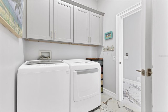 303 11th Ave E, Palmetto, FL 34221 - washroom with light marble finish flooring, washer and clothes dryer, cabinet space, and baseboards