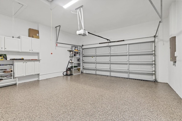 303 11th Ave E, Palmetto, FL 34221 - garage with a garage door opener and electric panel