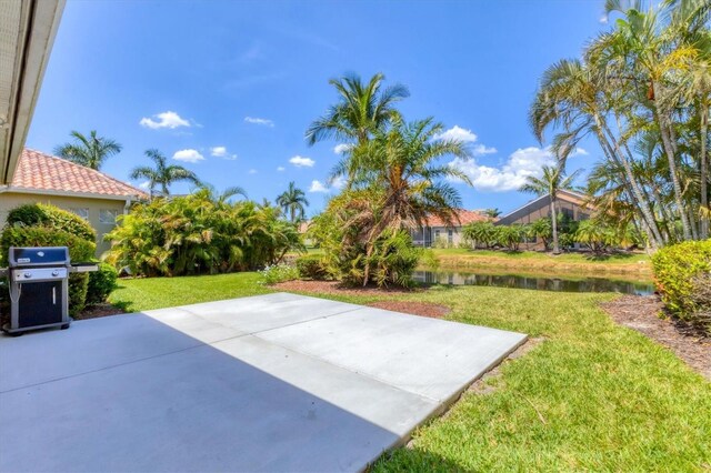 303 11th Ave E, Palmetto, FL 34221 - view of patio featuring a grill and a water view