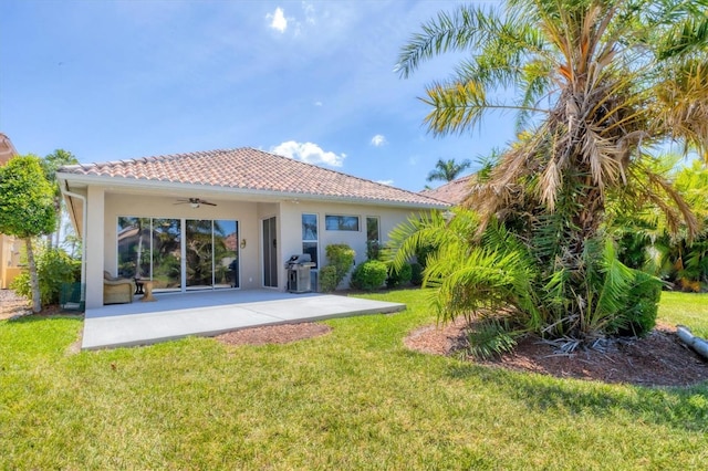303 11th Ave E, Palmetto, FL 34221 - rear view of property with a ceiling fan, a lawn, stucco siding, and a patio area