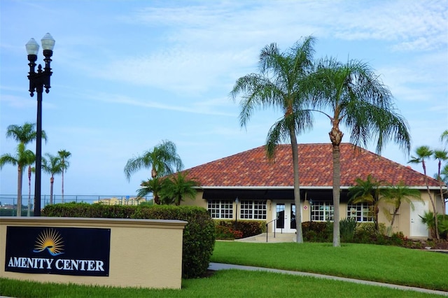 303 11th Ave E, Palmetto, FL 34221 - exterior space with a front yard, stucco siding, a tiled roof, and french doors