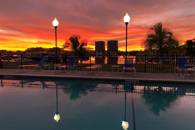303 11th Ave E, Palmetto, FL 34221 - pool at dusk featuring fence and a community pool