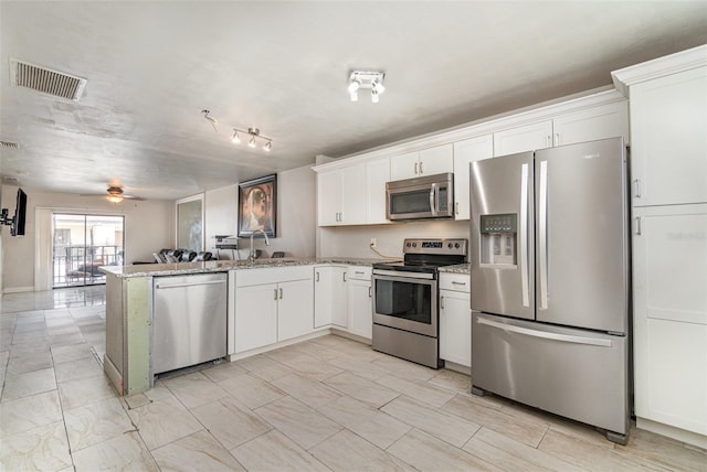 4516 Santa Barbara Blvd Unit 1, Cape Coral, FL 33914 - kitchen featuring ceiling fan, appliances with stainless steel finishes, a peninsula, white cabinetry, and visible vents