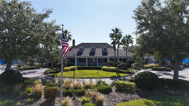 view of front of home with a front yard and a chimney