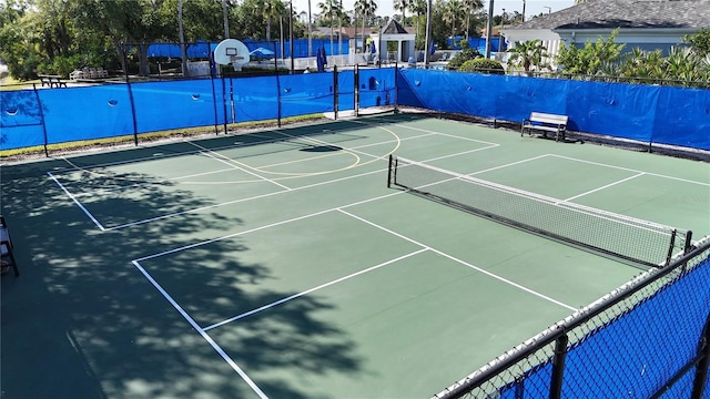 exterior space featuring community basketball court and fence