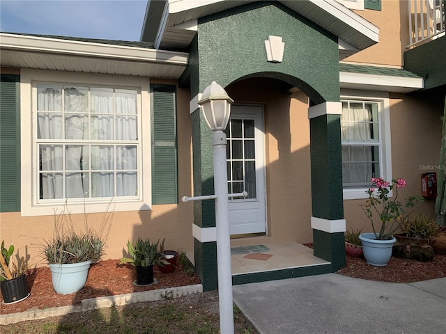 property entrance with stucco siding