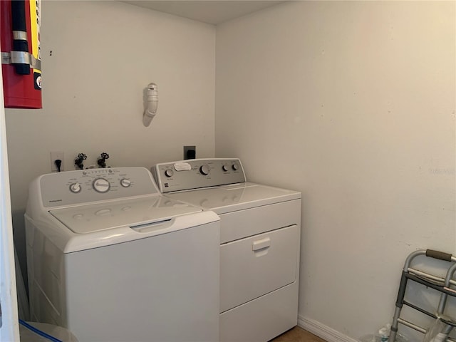 washroom with separate washer and dryer and laundry area