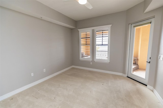 empty room with light carpet, baseboards, and a ceiling fan