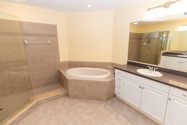 bathroom featuring a bath, a walk in shower, tile patterned flooring, and a sink