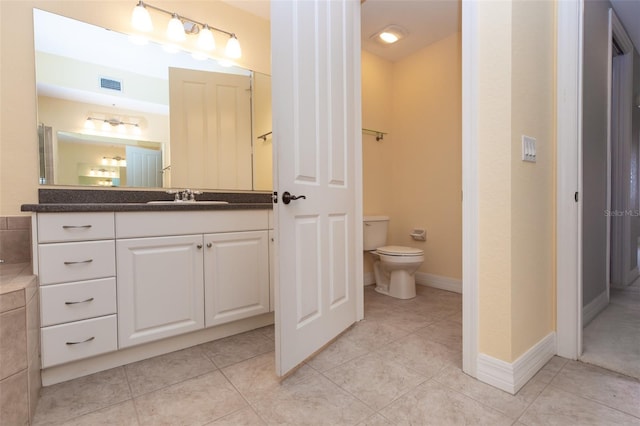 bathroom featuring toilet, tile patterned flooring, vanity, and visible vents