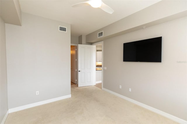 unfurnished bedroom with light carpet, baseboards, a ceiling fan, and visible vents