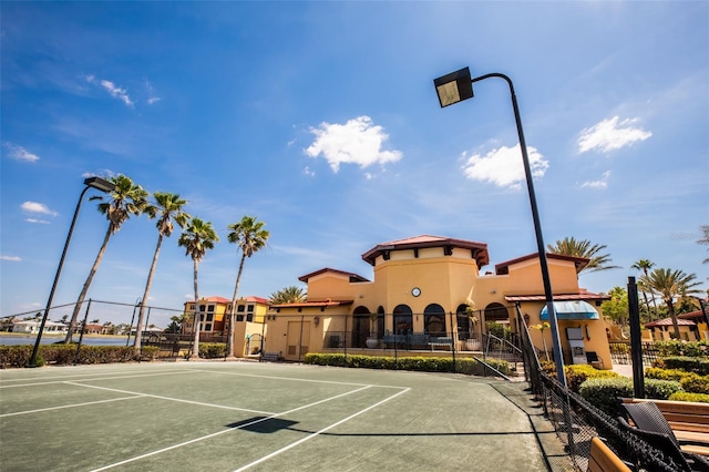 view of tennis court featuring fence