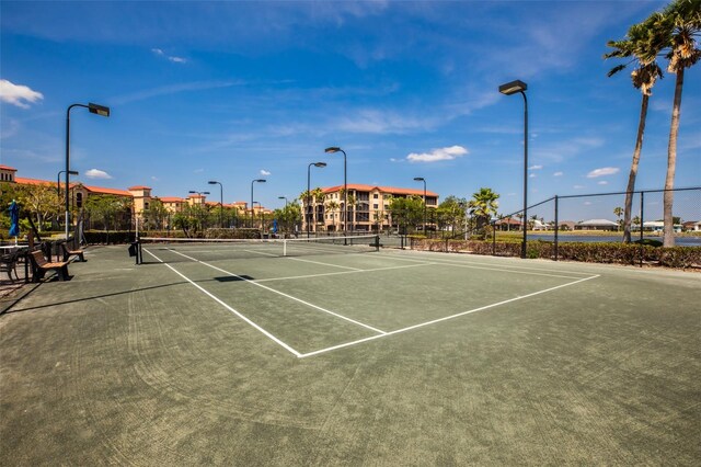 view of tennis court featuring fence