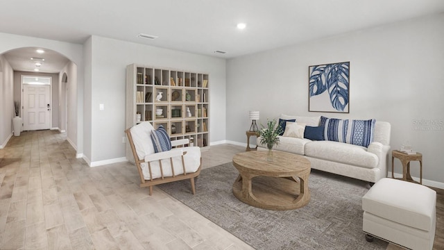 4960 Tuscola Blvd, North Port, FL 34287 - living room with arched walkways, wood finished floors, and recessed lighting
