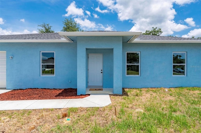 21480 Eldred Ave, Port Charlotte, FL 33952 - single story home with a front yard, roof with shingles, and stucco siding