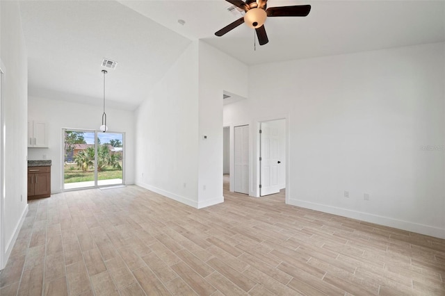 21480 Eldred Ave, Port Charlotte, FL 33952 - unfurnished living room with a ceiling fan, baseboards, high vaulted ceiling, and light wood-style floors