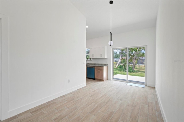 21480 Eldred Ave, Port Charlotte, FL 33952 - unfurnished living room featuring baseboards and light wood-type flooring