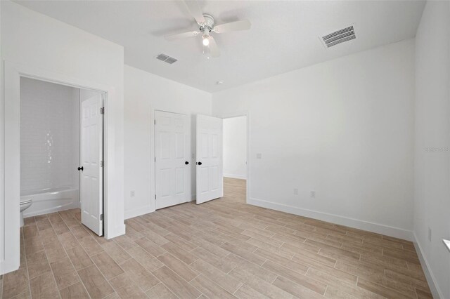 21480 Eldred Ave, Port Charlotte, FL 33952 - unfurnished bedroom featuring light wood-type flooring, baseboards, and connected bathroom